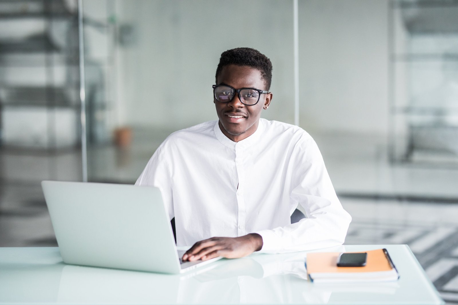 Smart young afro american businessman looking at the computer in office