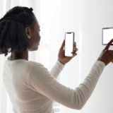 Woman pressing on smart home automation panel monitor